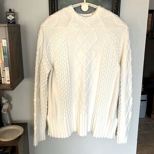 Cyrus acrylic sweater, size XL. Off white; side slits for comfort.